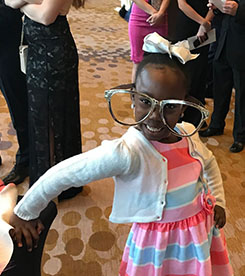 'Bigs in Blue' Shows the Power of Mentoring Little girl wearing humorously large glasses