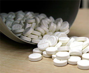 OJP provides law enforcement with the tools and information they need to mitigate the risks associated with the opioid crisis spilled bottle of Fentanyl pills