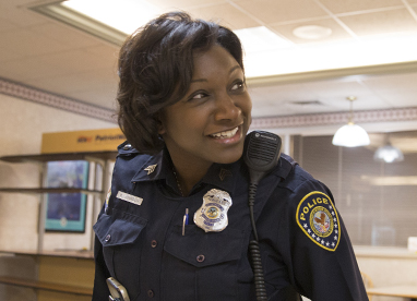 Smiling female officer in precinct