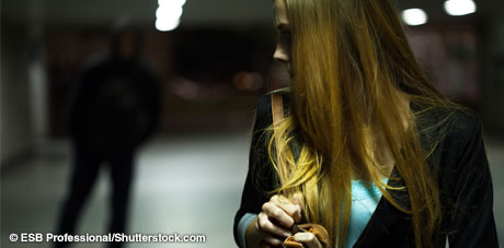 Image of female looking back at a figure in shadow