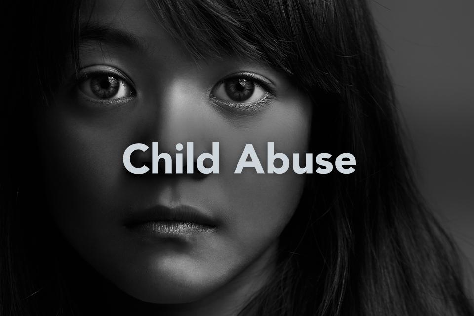 Child Abuse text on background of child's face